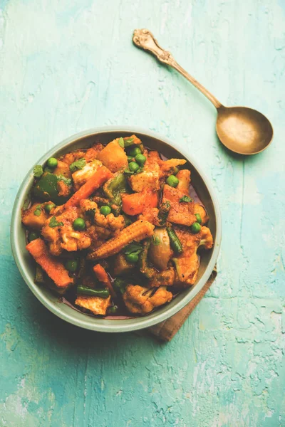 Mix vegetable curry - Indian main course recipe contains Carrots, cauliflower, green peas and beans, baby corn, capsicum and paneer/cottage cheese with traditional masala and curry, selective focus