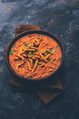 Dhaba tarzı Sev bhaji / sabzi / köri gathiya shev ile domates köri yapılan, bir kase veya karahi, seçici odak servis