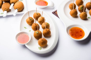 Gevrek Sebze lolipop tarifi mısır unu ve ekmek kırıntıları kaplama ile kaplı baharat ile haşlanmış patates kullanılarak yapılan ve daha sonra derin kızarmış, kürdan veya dondurma stok sos ile eklenen ile servis