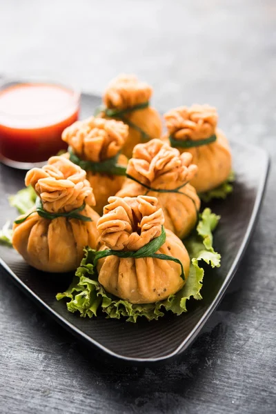 Crispy Potli Samosa or veg money bags are delicious Indian snacks of spiced aloo and mix veggies Or Meat/kheema  stuffed in flaky dough. It\'s a great creative starter or appetiser. served with ketchup