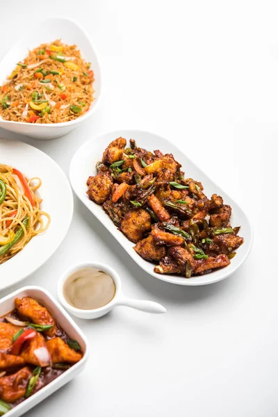 Assorted Indo chinese food in group includes Schezwan/Szechuan hakka noodles, veg fried rice, veg manchurian, american chop suey, chilli paneer, crispy vegetable and vegetable soup