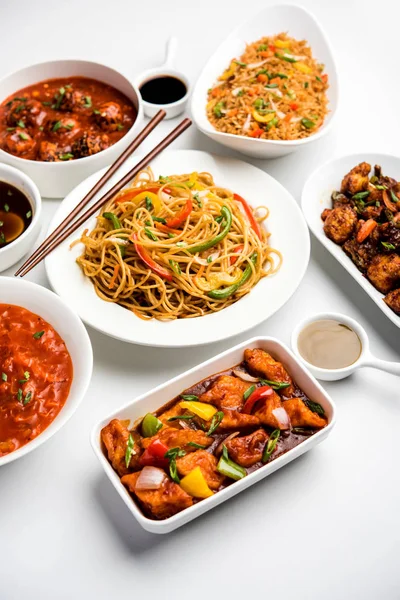 Assorted Indo chinese food in group includes Schezwan/Szechuan hakka noodles, veg fried rice, veg manchurian, american chop suey, chilli paneer, crispy vegetable and vegetable soup