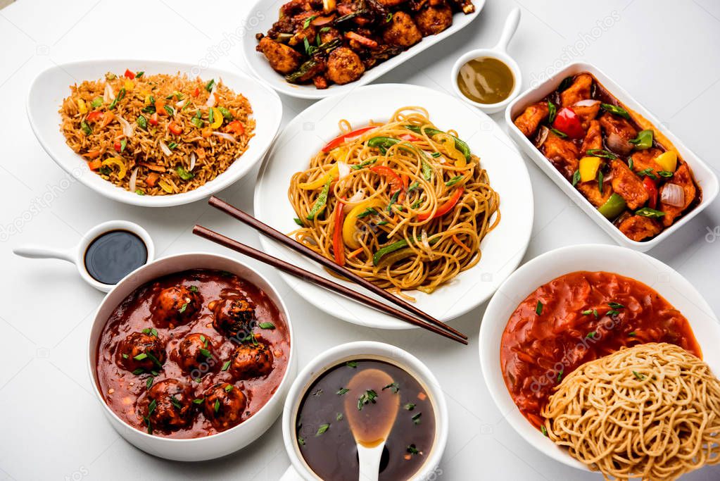 Assorted Indo chinese food in group includes Schezwan/Szechuan hakka noodles, veg fried rice, veg manchurian, american chop suey, chilli paneer, crispy vegetable and vegetable soup