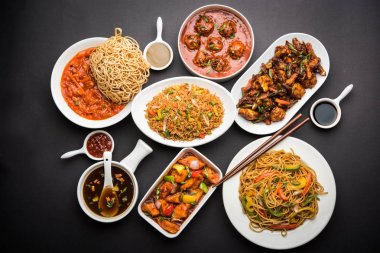 Assorted Indo chinese food in group includes Schezwan/Szechuan hakka noodles, veg fried rice, veg manchurian, american chop suey, chilli paneer, crispy vegetable and vegetable soup clipart