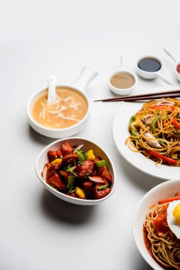 Çeşitli Indo çin gıda grup olmayan vejetaryen veya tavuk Schezwan / Szechuan hakka erişte, kızarmış pirinç, mançurya, yumurta amerikan pirzola suey, kaşık ve doğrama çubukları ile çorba, seçici odak içerir