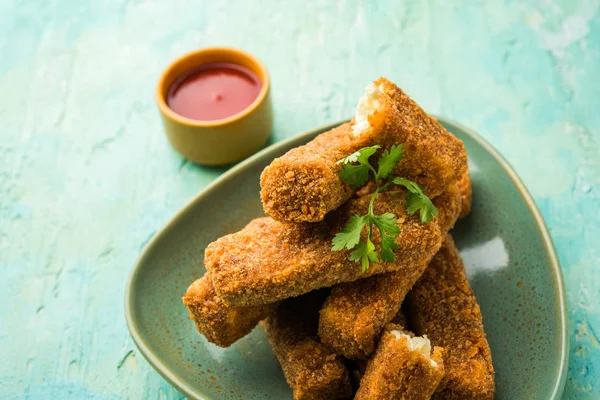 stock image Kurkuri paneer fingers or pakora/pakoda snacks also known as Crispy Cottage Cheese Bars, served with tomato ketchup as a starter. selective focus