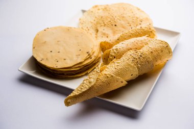 Kavrulmuş koni, rulo ve düz varyasyon ile çiğ kurutulmuş formda Gujarati Papad veya Papadum