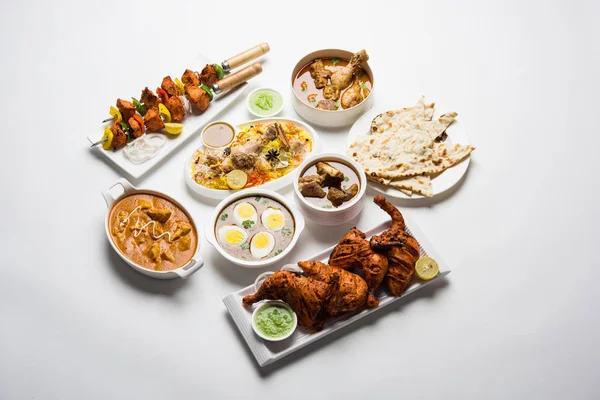 Assorted Indian Non Vegetarian food recipe served in a group. Includes Chicken Curry, Mutton Masala, Anda/egg curry, Butter chicken, biryani, tandoori murg, chicken-tikka and naan/roti