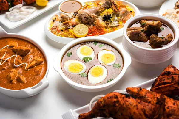 Assorted Indian Non Vegetarian food recipe served in a group. Includes Chicken Curry, Mutton Masala, Anda/egg curry, Butter chicken, biryani, tandoori murg, chicken-tikka and naan/roti