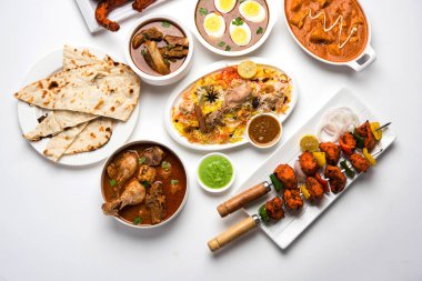 Assorted Indian Non Vegetarian food recipe served in a group. Includes Chicken Curry, Mutton Masala, Anda/egg curry, Butter chicken, biryani, tandoori murg, chicken-tikka and naan/roti clipart