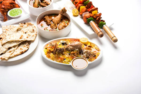 Assorted Indian Non Vegetarian food recipe served in a group. Includes Chicken Curry, Mutton Masala, Anda/egg curry, Butter chicken, biryani, tandoori murg, chicken-tikka and naan/roti