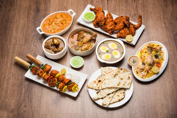 Assorted Indian Non Vegetarian food recipe served in a group. Includes Chicken Curry, Mutton Masala, Anda/egg curry, Butter chicken, biryani, tandoori murg, chicken-tikka and naan/roti