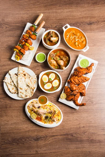 Assorted Indian Non Vegetarian food recipe served in a group. Includes Chicken Curry, Mutton Masala, Anda/egg curry, Butter chicken, biryani, tandoori murg, chicken-tikka and naan/roti