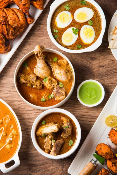 Assorted Indian Non Vegetarian food recipe served in a group. Includes Chicken Curry, Mutton Masala, Anda/egg curry, Butter chicken, biryani, tandoori murg, chicken-tikka and naan/roti