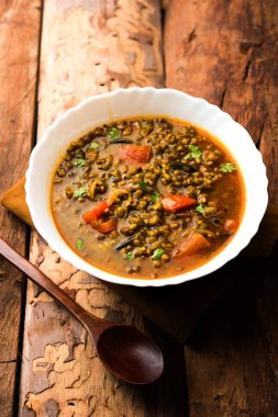 Tadka 'nın tüm yeşil Moong Dal kızartması ve tüm Mung fasulyesi bir kasede servis edilir. seçici odak