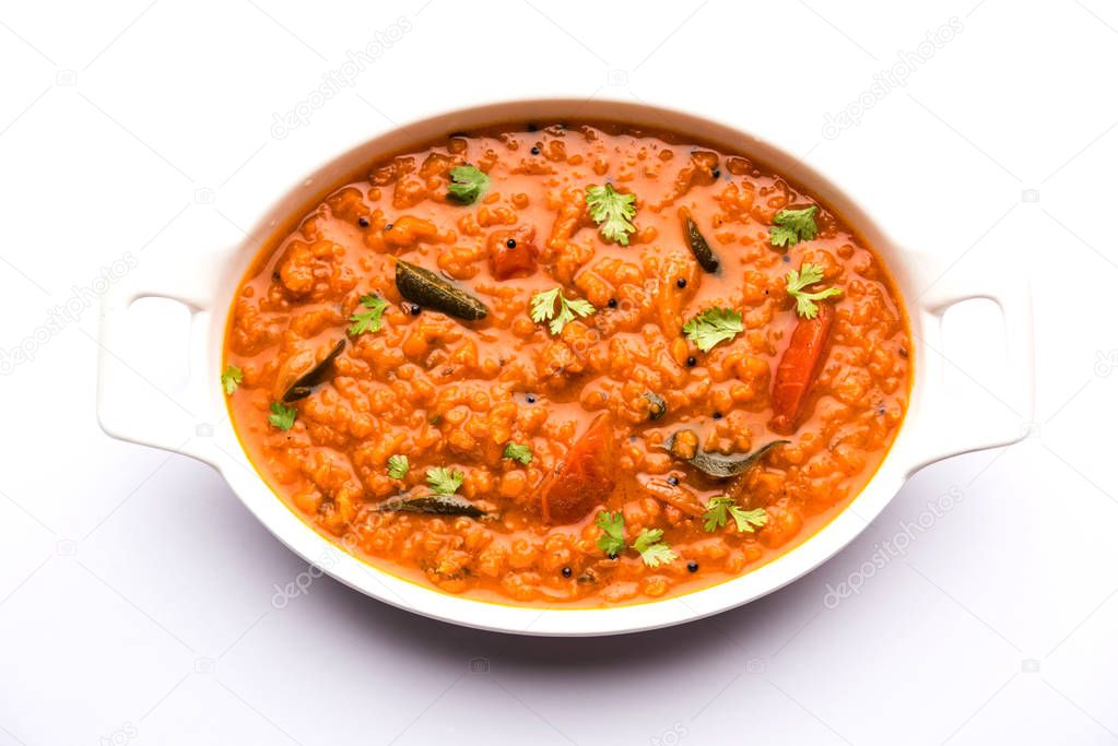 Red Lentil Cooked Dal or Dhal or Masoor daal tadka served in a bowl, selective focus