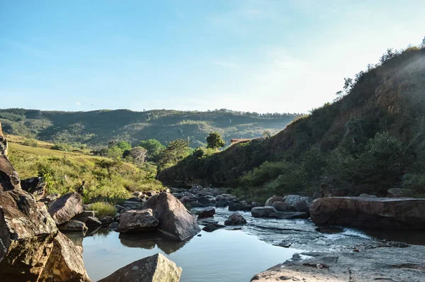 un rio entre las colinas en un dia soleado