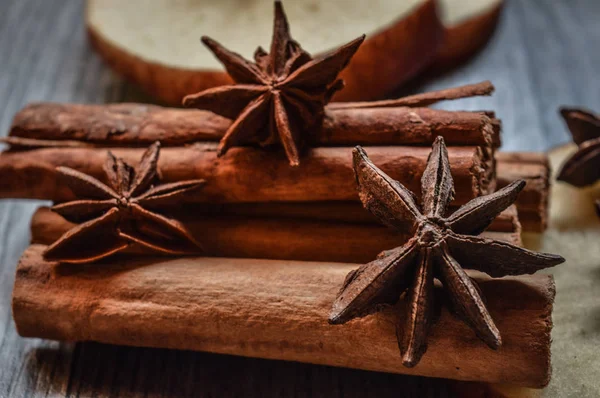 Yıldız anason, tarçın ve ahşap arka plan üzerinde elma