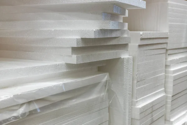 Stacks of polystyrene foam in packaging at a building materials warehouse in a store. The insulation is in the distribution warehouse.