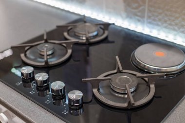 Cooking kitchen surface with gas and electric heater. Combined stove in the kitchen.