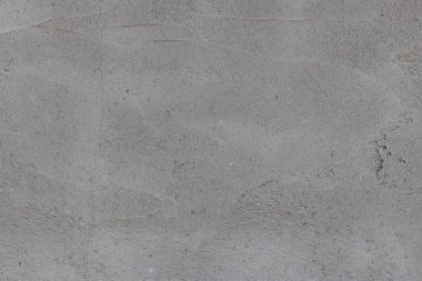 Beton alçılı koyu gri beton duvar. Düz olmayan alçılı, arka planlı gri bir duvar dokusu.
