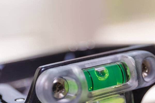 Liquid device for regulating the level of the horizon on a tripod, macrophotography with copy space