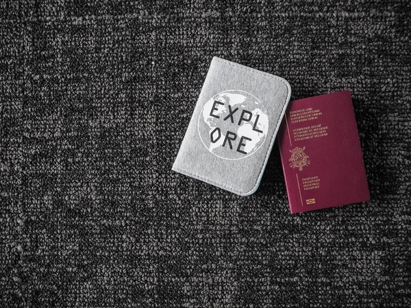 Belgian passport and inspirational passport cover with the quote 'Explore' on a dark background