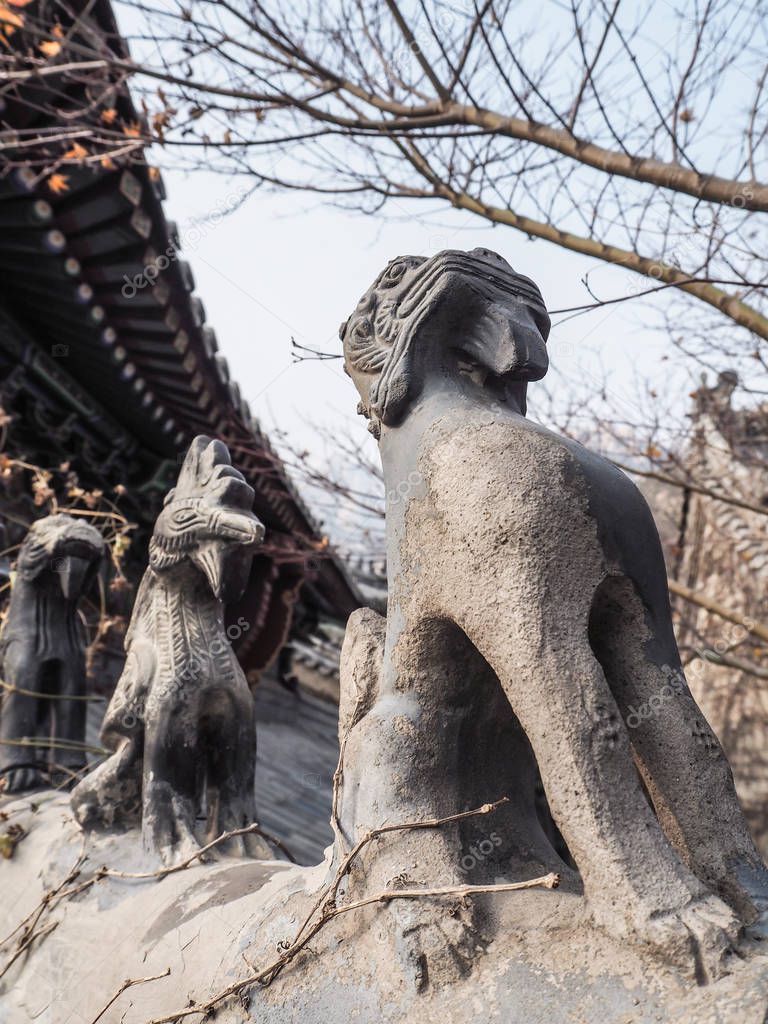 Row of stone roof figurines at the Huayan temple at mountain Laoshan, Qingdao, China