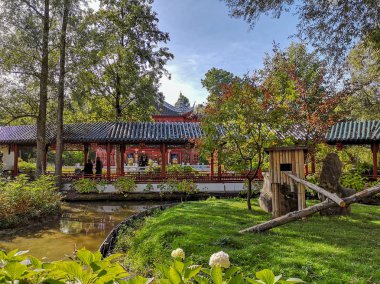September 2018 - Brugelette, Belgium: The authentic Chinese garden home to the panda's in the wildlife park Pairi Daiza, with traditional architecture clipart