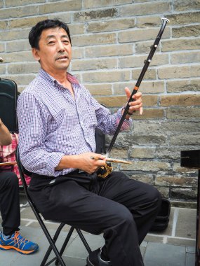Beijing, China - September 2017: Chinese man playing the Chinese clipart
