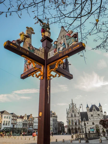 Ornamental wooden signpost with the directions to Mechelen\'s main tourist landmarks such as Hof van Busleyden, Saint Rumbolds Cathedral and city hall.