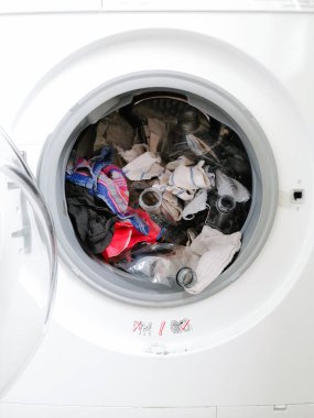 Washing machine filled with plastic waste representing micro plastic waste pollution during laundry clipart