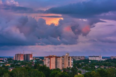 Gökyüzü bulutlu gün batımında akşam şehir üzerinde.