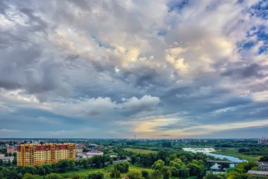 Gökyüzü bulutlu gün batımında akşam şehir üzerinde.