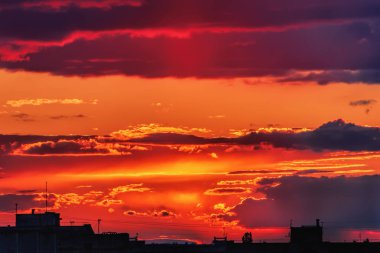 Gün batımında gökyüzü ve bulutlar akşam şehrin siluet binaları üzerinde.