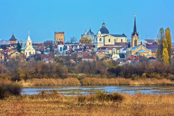 Autumn landscape - churches, temples and old houses on the banks of the river (The city of Lutsk, Ukraine).