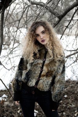 Kürk ceket açık havada duran genç kadın