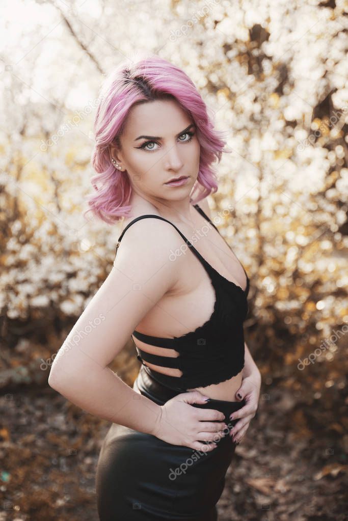 Portrait of beautiful woman with dyed pink hair
