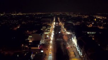 Havadan çekim gece şehir, çatılar, sokaklarda gece trafik ışıkları ile