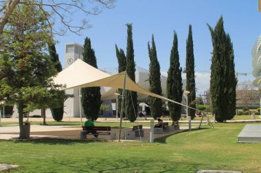 Lefkoşa, Kıbrıs, 7 Mayıs 2019: Güneşli bir günde Kıbrıs Üniversitesi Kampüsü'nde çimenlik, bankve ağaçlarda güneş barınağı