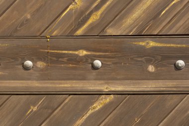 Kahverengi ve sarı doğal ahşap yüzey dokusu, üç gri tırnak başı ve küçük reçine damlası.