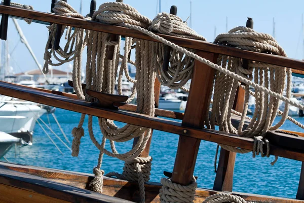 Close-up of ropes on wooden boat moored at sea harbor
