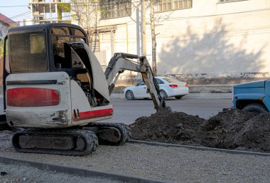 Mini kazıcı toprağı kazıyor.