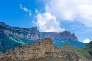 Gökyüzü ve bulutların arka planında dağlar