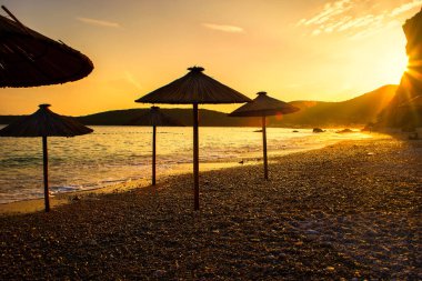 Karadağ 'ın (Adriyatik Denizi) Budva kenti yakınlarındaki Jaz plajında güzel bir günbatımı. Seyahat kavramı, arkaplan.