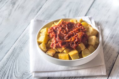 Portion of patatas bravas with sauces clipart