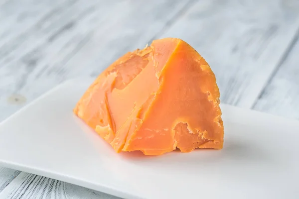 Wedge Mimolette Cheese White Plate — Stock Photo, Image