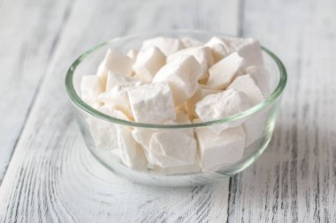 Ahşap zemin üzerinde bir kase beyaz şeker.