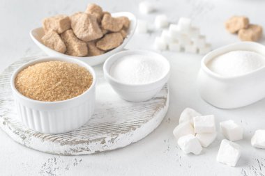 Ahşap arka planda farklı şekillerde şeker var.