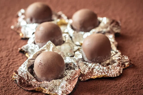 Chocolate truffles on cocoa background — Stock Photo, Image